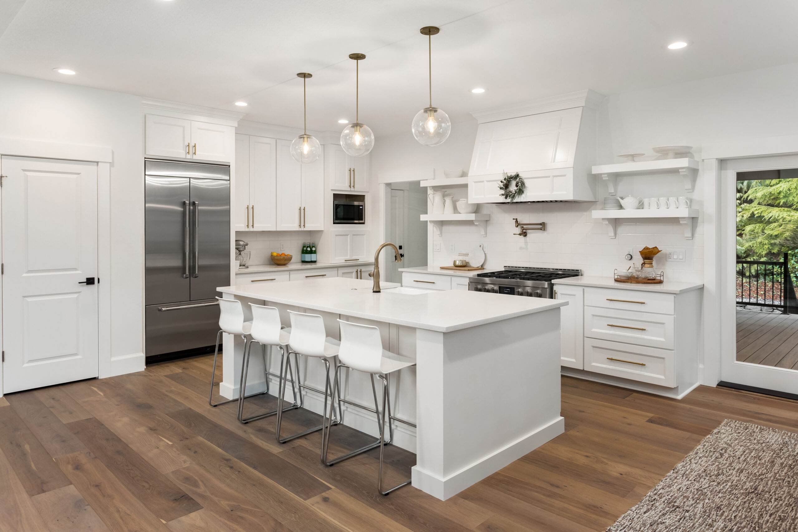 beautiful kitchen in new luxury home with island, pendant lights