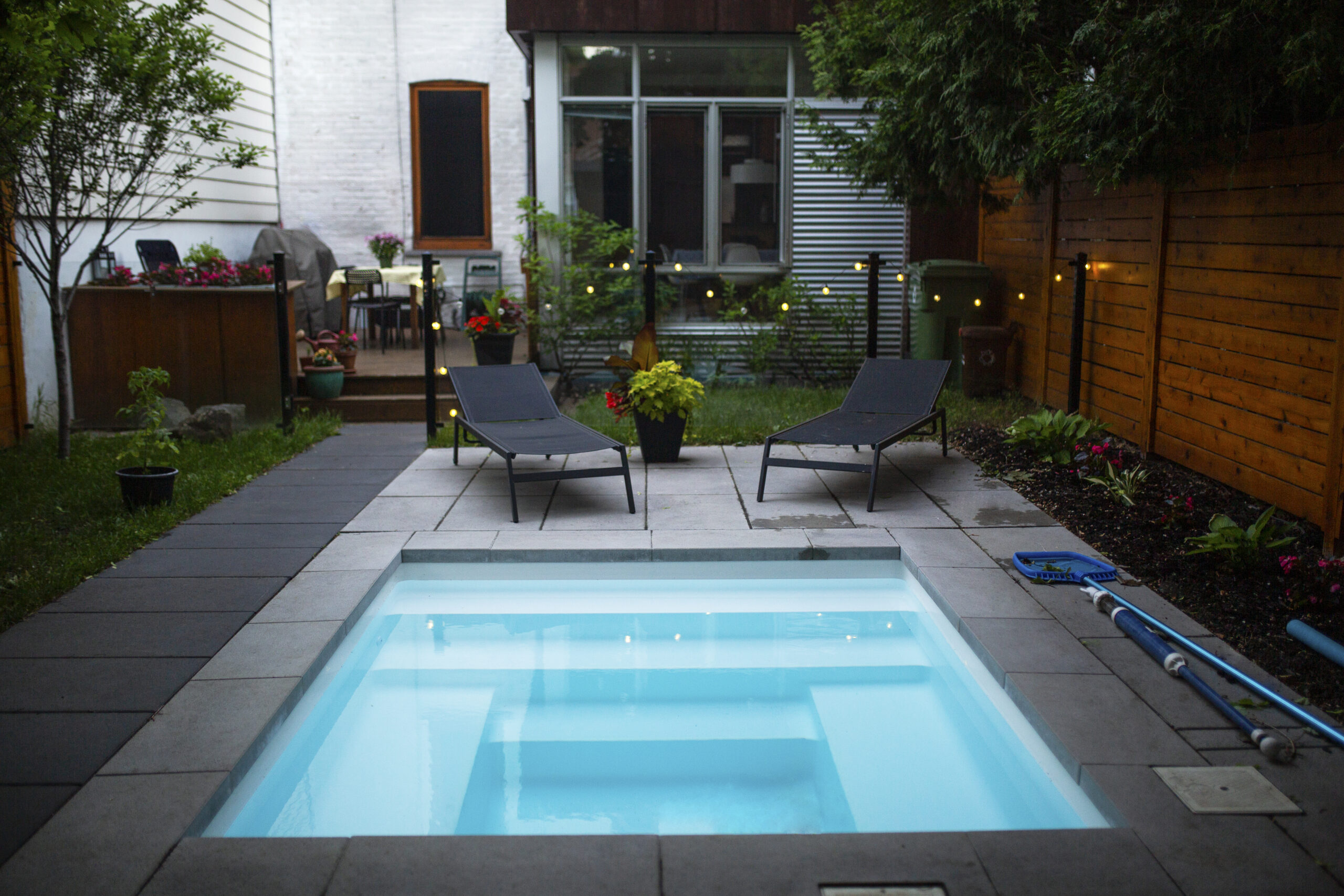 Back yard with a small swimming pool